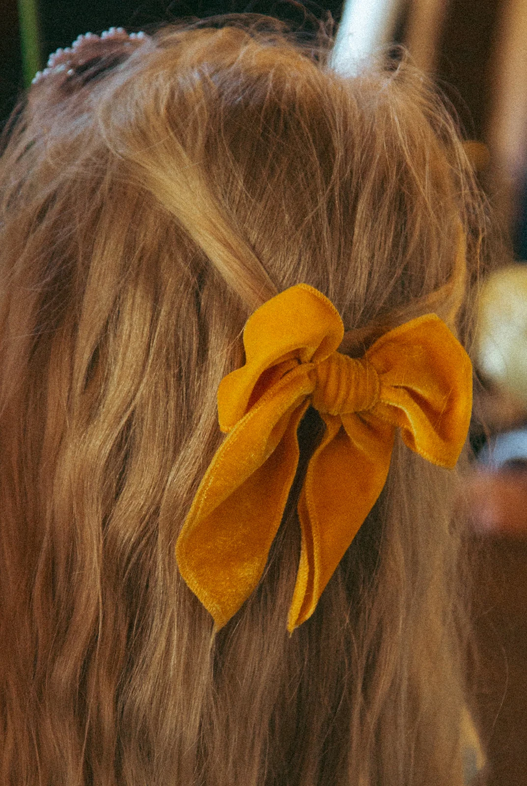 An orange bow in the hair